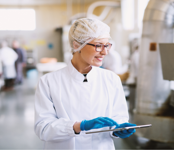 Technician in cleanroom suit using tablet in laboratory Rectangle