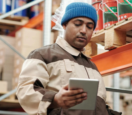 Warehouse worker using tablet for inventory management